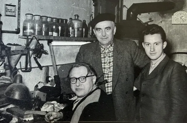 Historisches Schwarz-Weiß-Foto der Goldschmiedewerkstatt Grützmacher, drei Generationen bei der Arbeit